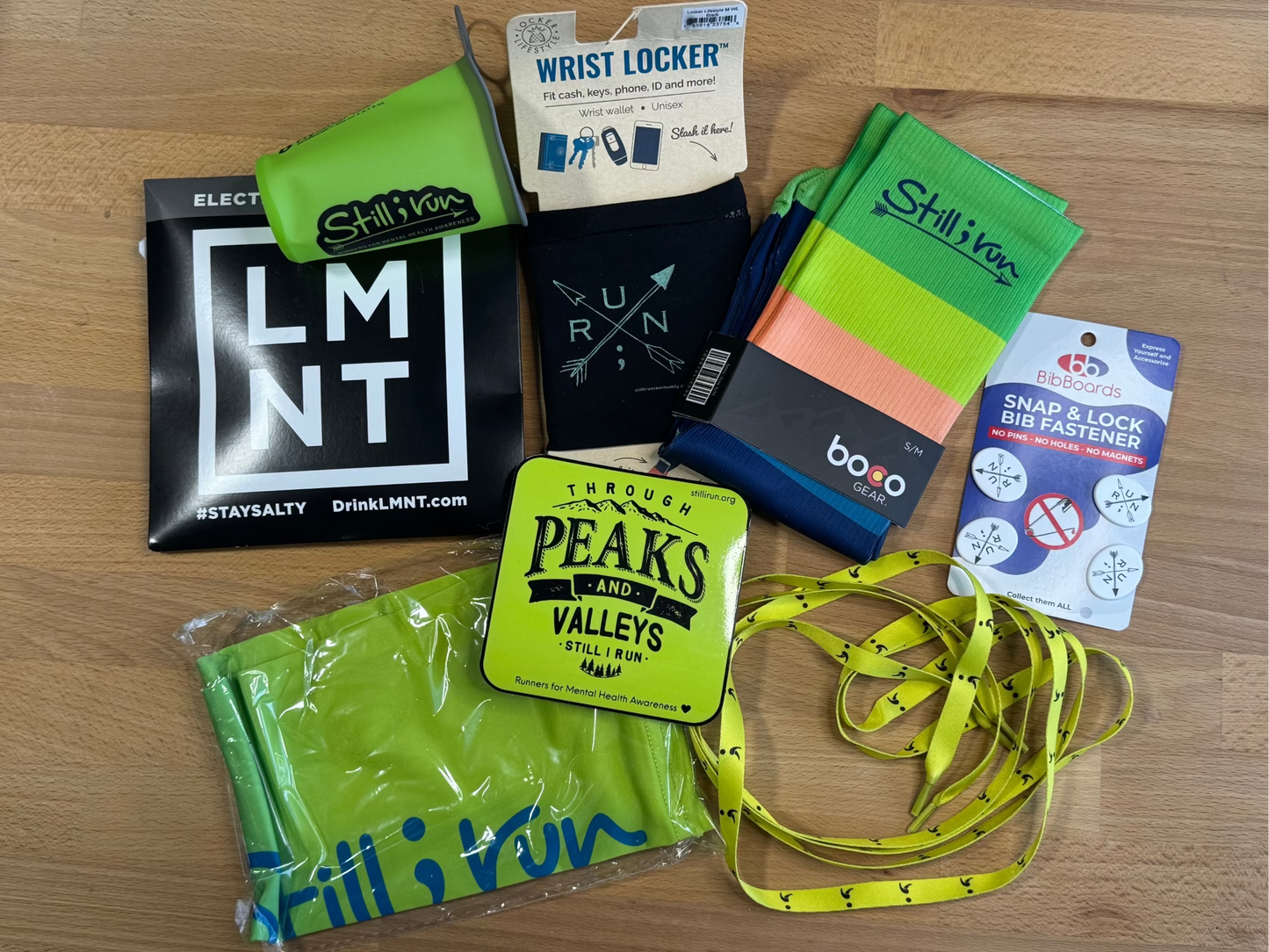 Collection of sports accessories including socks, SpeedCup™, arm sleeves, shoe laces, and bib boards