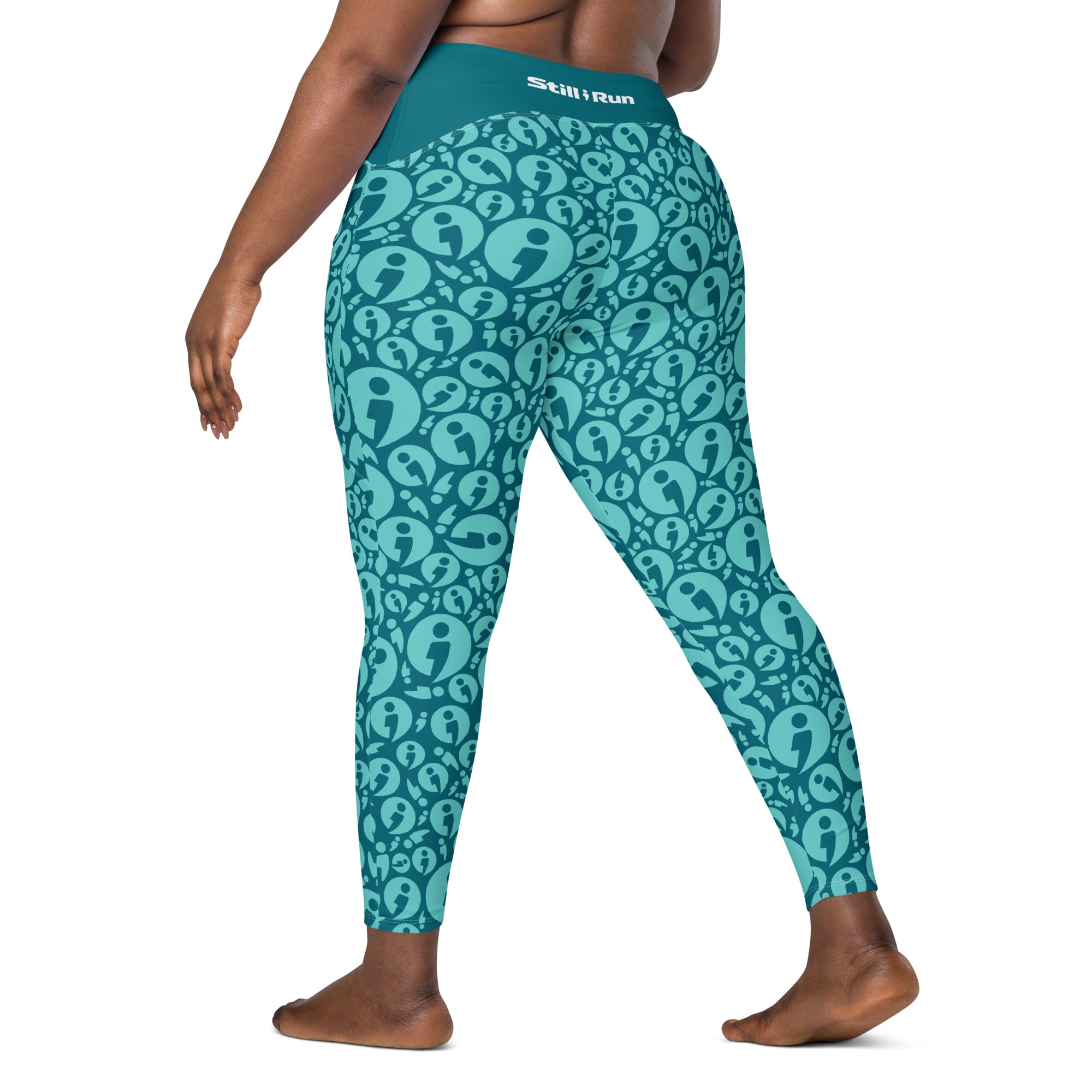 A model from the back wearing teal and light blue patterned leggings with a repeating Still I Run avatar design and a visible 'Still Run' brand on the waistband, set against a plain white background.